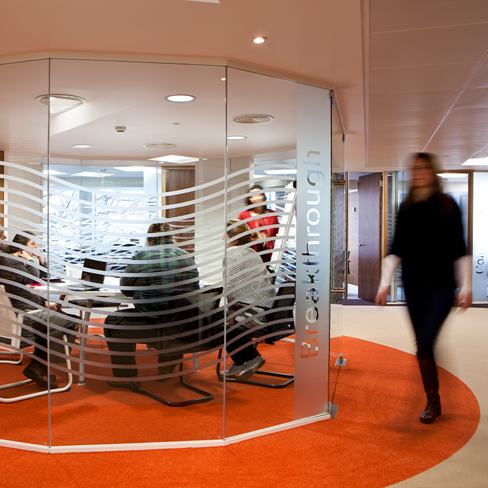 Modern office meeting space with glass walls and 