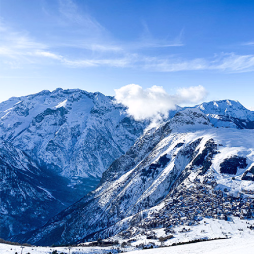 Snow covered mountains with a ski village at the mountain base