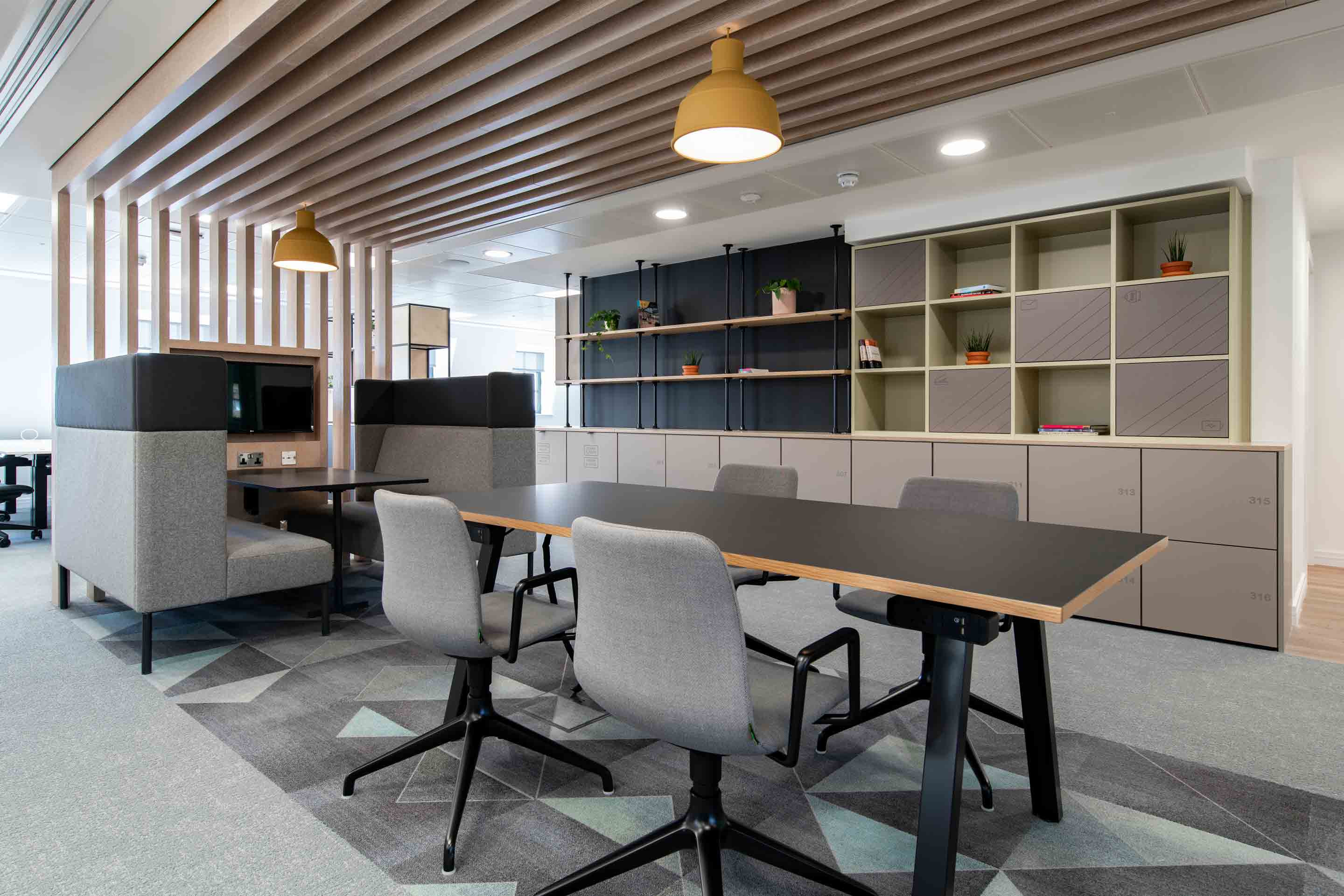 Open plan workspace with desks and shelving